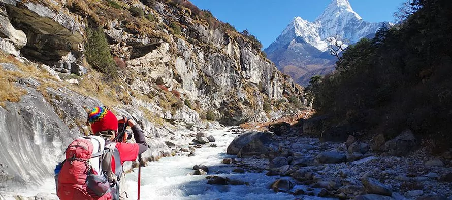 Hiker walking through a mountain valley