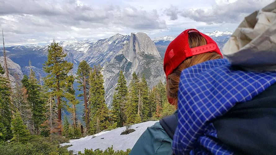 close up of hiker with trees and mountains