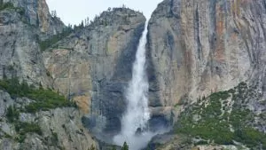 Huge waterfall between rocky mountains