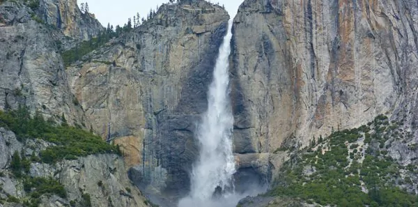 Huge waterfall between rocky mountains