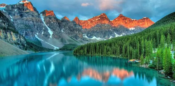 Turquoise water with large mountain range in background