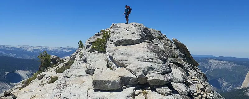 Hiker standing on rocky summit
