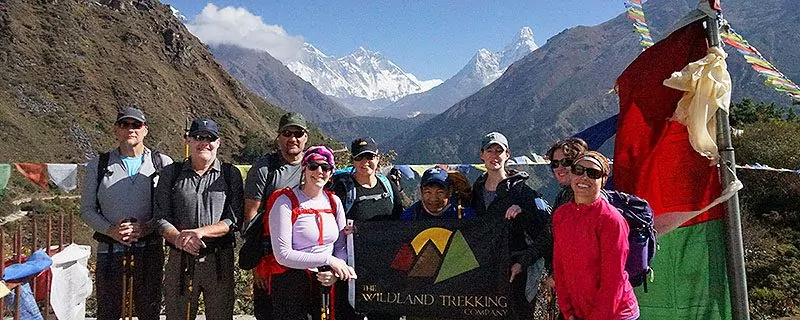 Hikers posing with Wildland Trekking flag