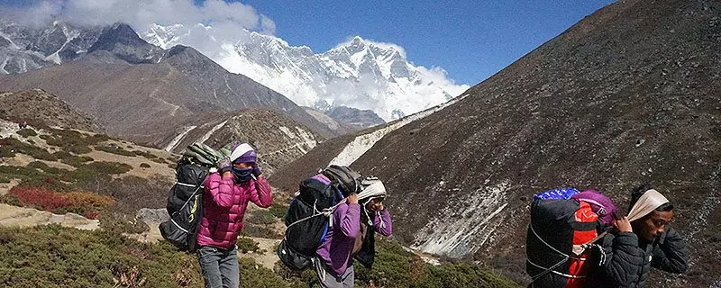 Hikers in foreground on Nepalese trail
