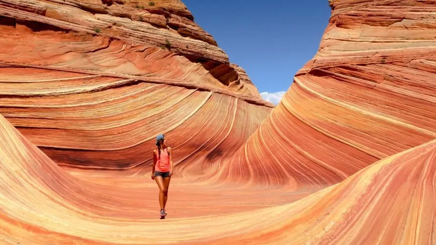 Woman walking through navajo sandstone