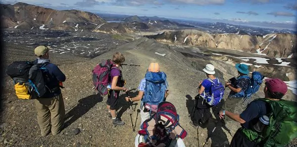 Hikers standing on rocky hill