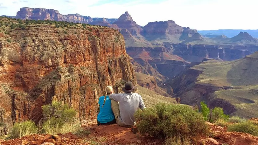 Two hikers overlooking cliff