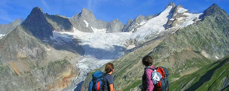 Hikers looking at massive glacier