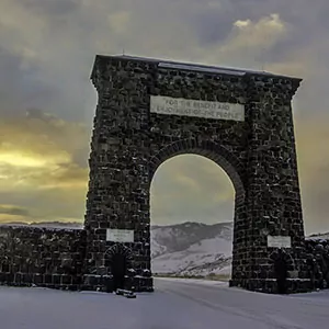Entrance stone archway to Yellowstone National Park during sunset