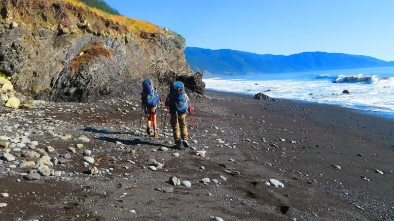 Two people backpacking on the Lost Coast of California