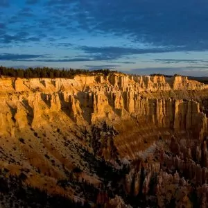 Sunset lighting illuminates the canyon rim at dusk.