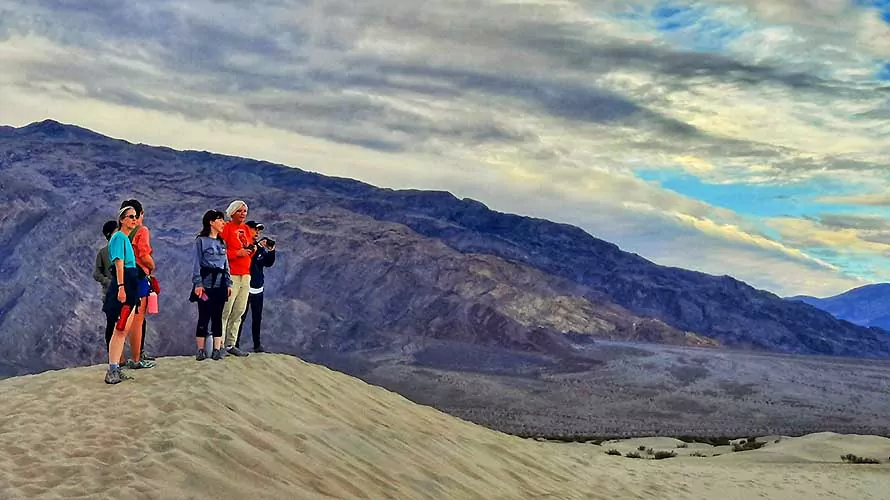 Group of women hikers looking out over the sand dunes in Death Valley, California
