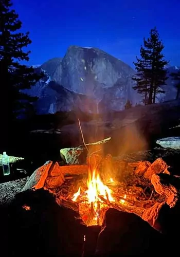 Campfire on the North Rim of Yosemite Valley with Half Dome behind