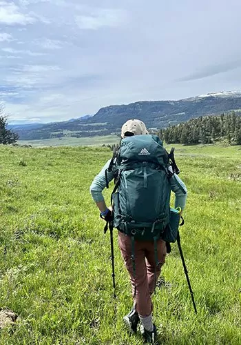 Backpacker in meadow in Yellowstone National Park