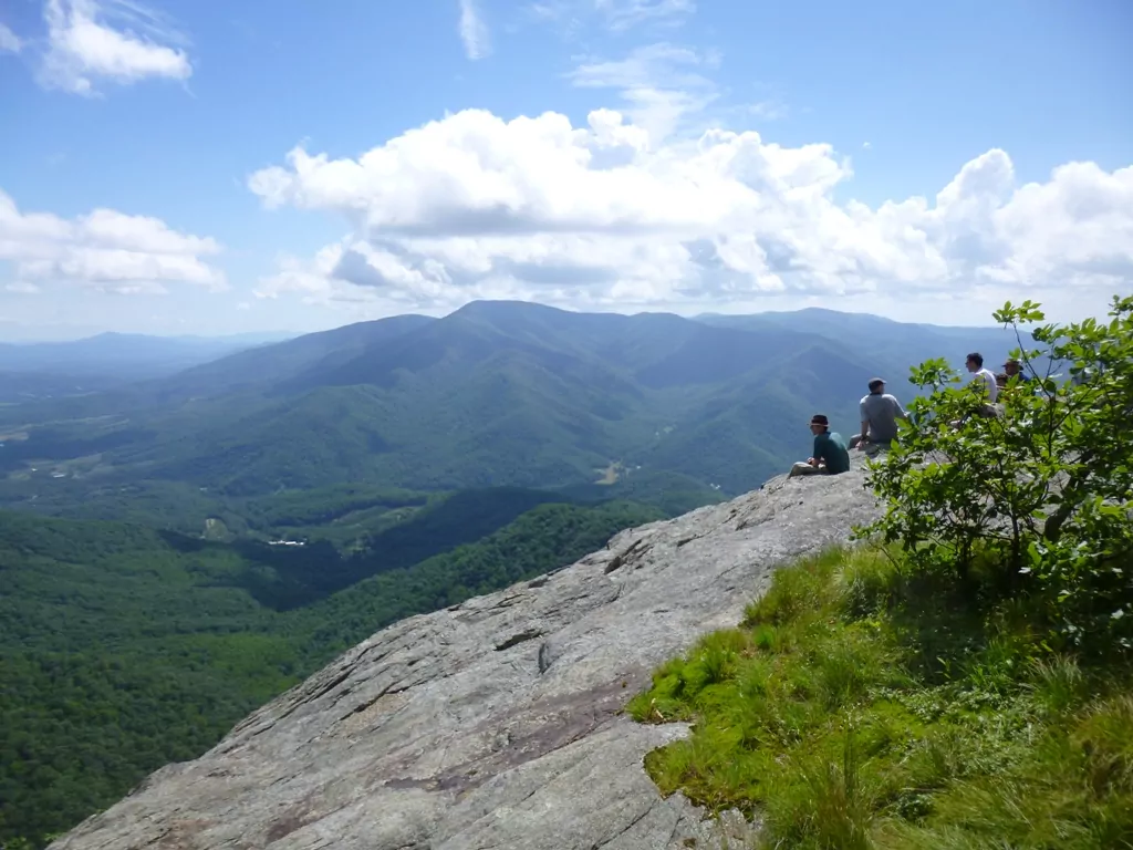 Hikers sit at an overlook in the Three Ridges Wilderness