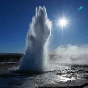 geyser Yellowstone in october basin water spring thermal features sky sun 