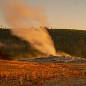 Yellowstone in September fall geyser steam hill red