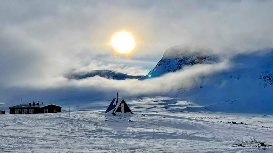 Skiers in the Arctic Circle on the Kungsleden Traverse