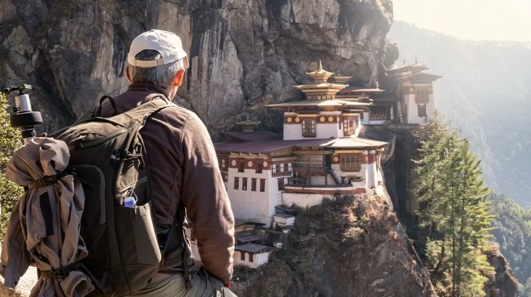 Hiking and trekking vacations in Bhutan, Bhutanese guided tours, hiking and walking tours, man overlooking monastery, mountain, buddhism