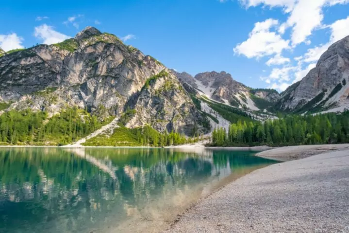 Lake in Dolomites mountains with clouds reflected in the water