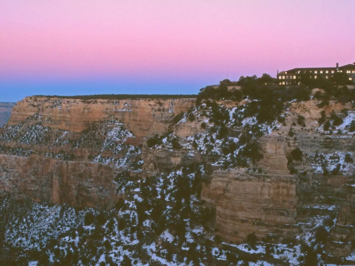 Historic El Tovar lodge sits perched on the South Rim of the Grand Canyon at sunset