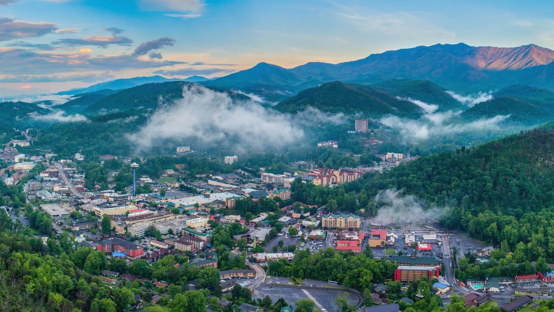 The town of Gatlinburg, Tennessee sits at the foot of the smoky mountains under a haze of clouds