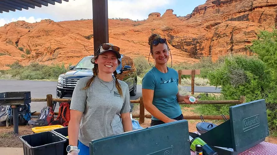 Two Wildland Trekking guides preparing dinner on a Utah camping tour