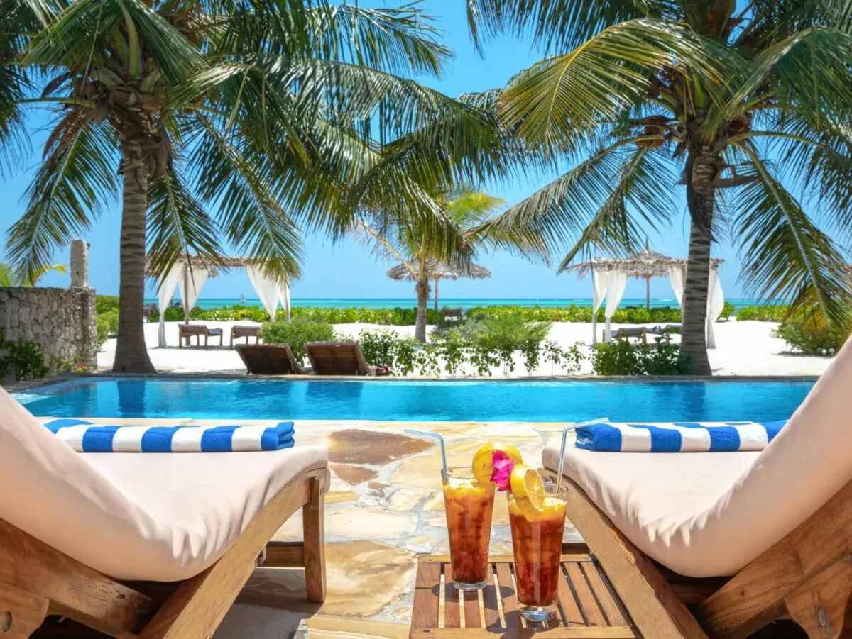 Beach chairs, sun and cocktails illustrate island vacation life