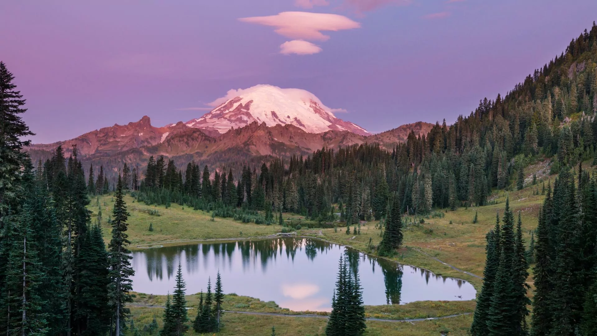 Mt. Rainier summit stands above alpine lake