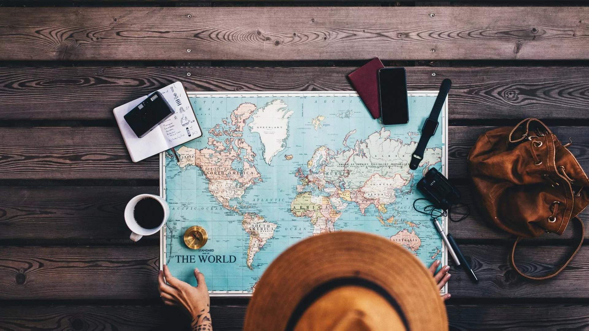 A traveller looks over a map of the world