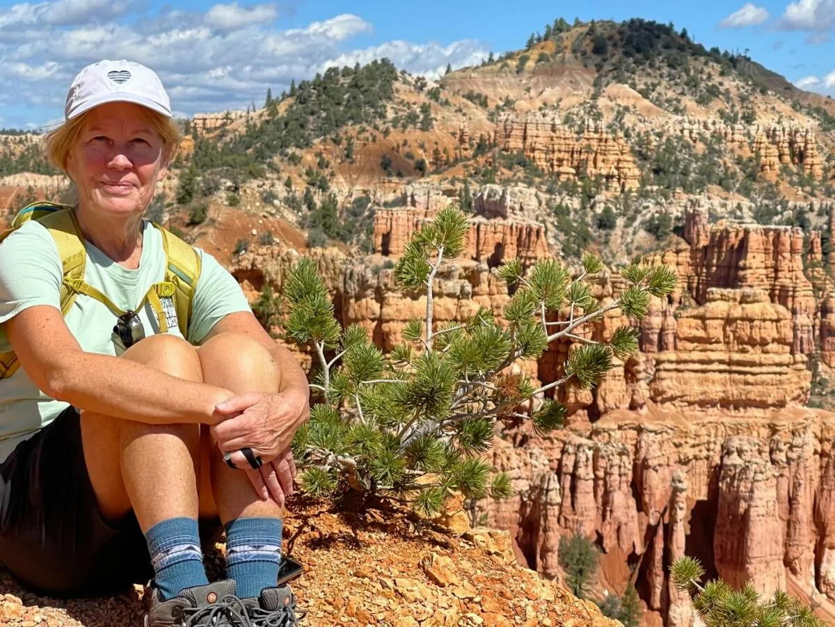 Hiker sits in front of a scenic view in Bryce National Park