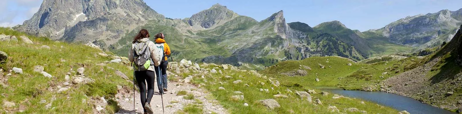 two hiker in front of the Midi d'Ossau and in the Ayous Lakes, Pyrenees, France