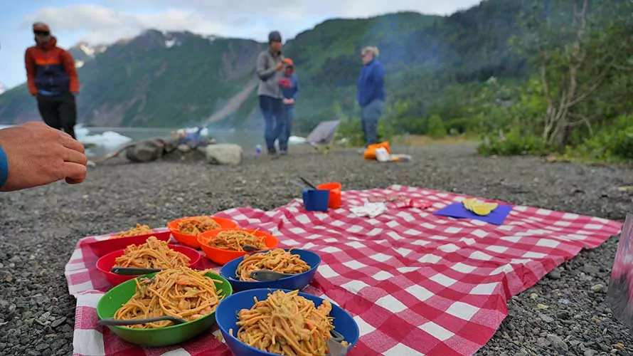Camping dinner on a table cloth on the beach in Kenai, Alaska