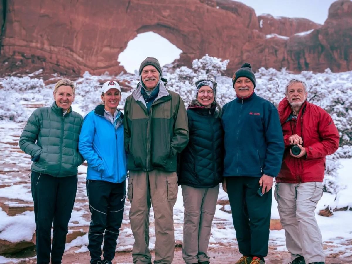 Happy hikers pose outside in the snow