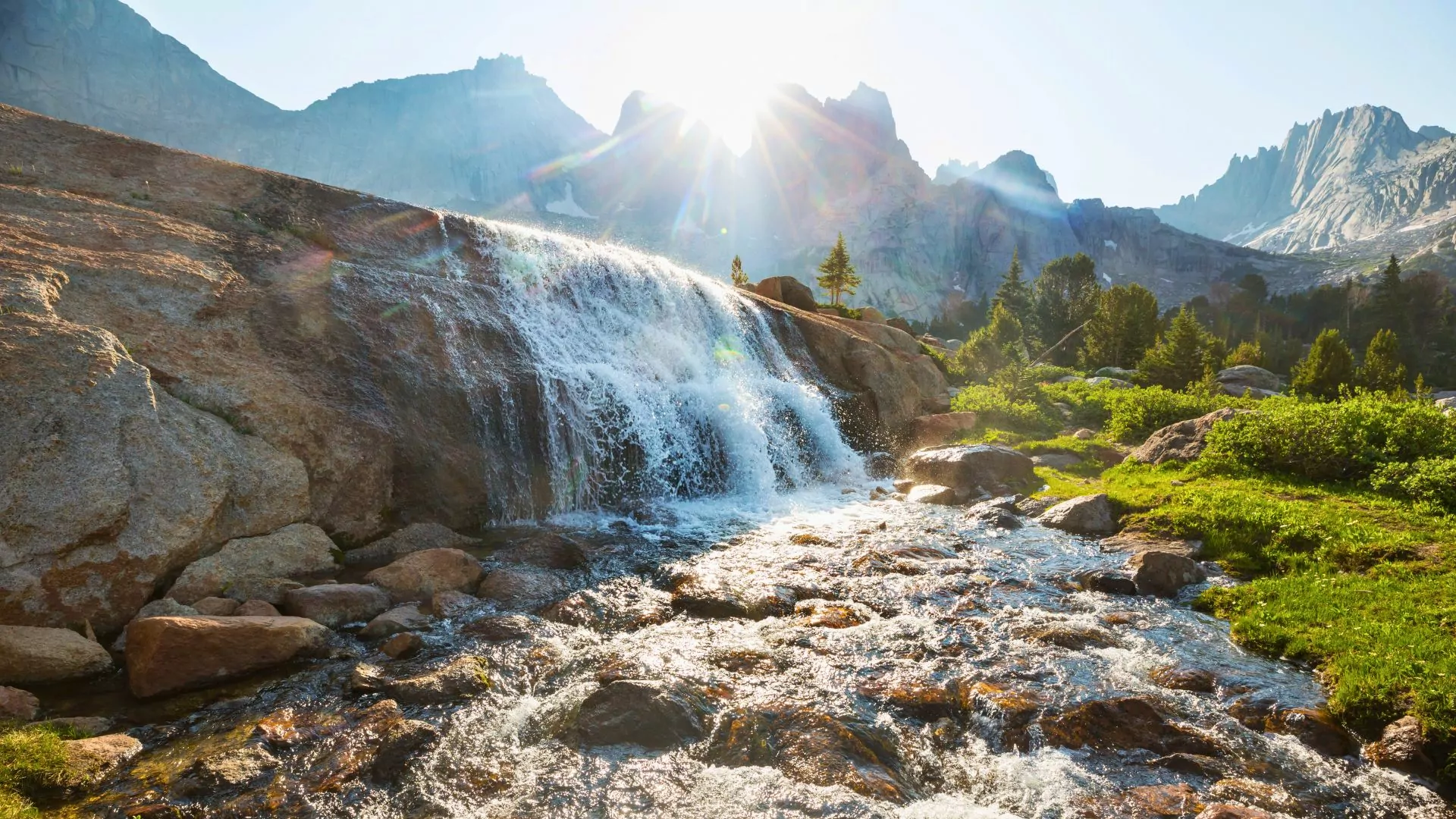 A waterfall pours from a creek in the wind river mountains