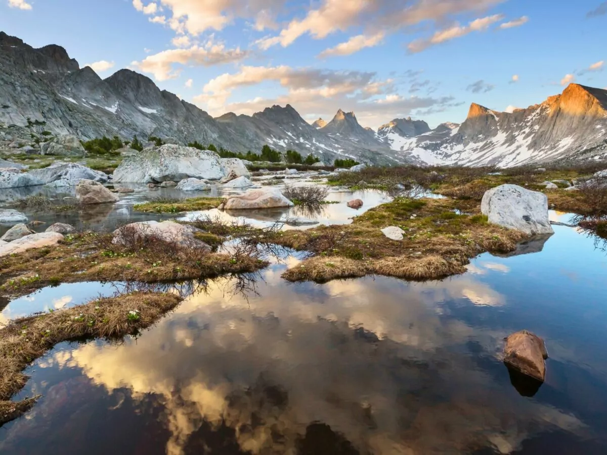 The sky reflects in an alpine lake in the wind river mountains