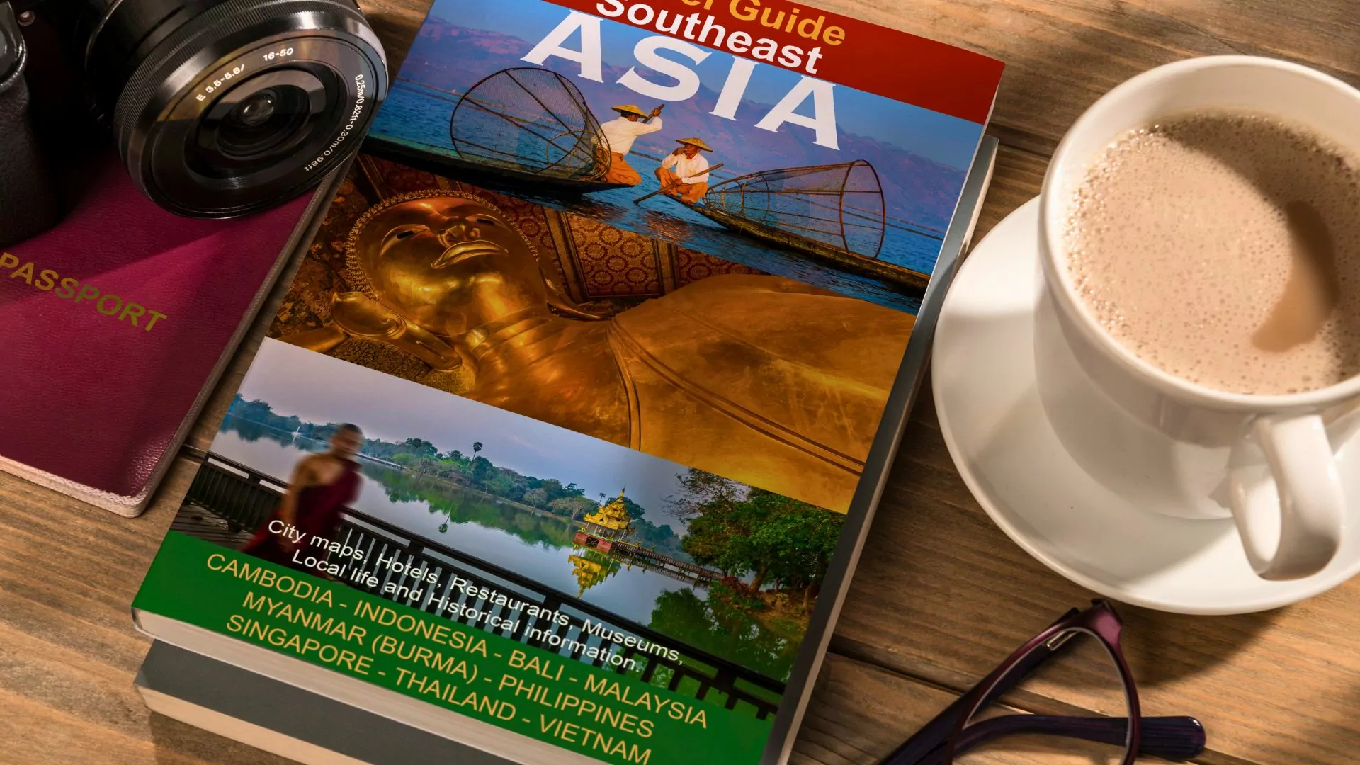A guide book to the countries of Asia sits on a table next to cup of coffee