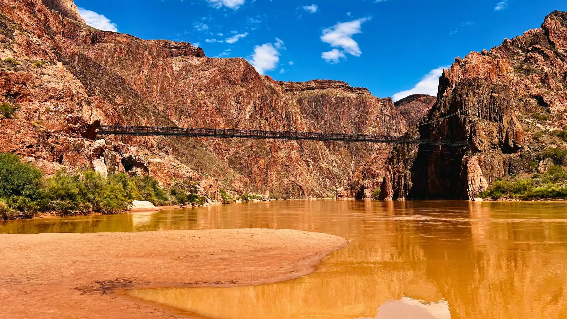 A bridge stretches over the Colorado River in the Grand Canyon