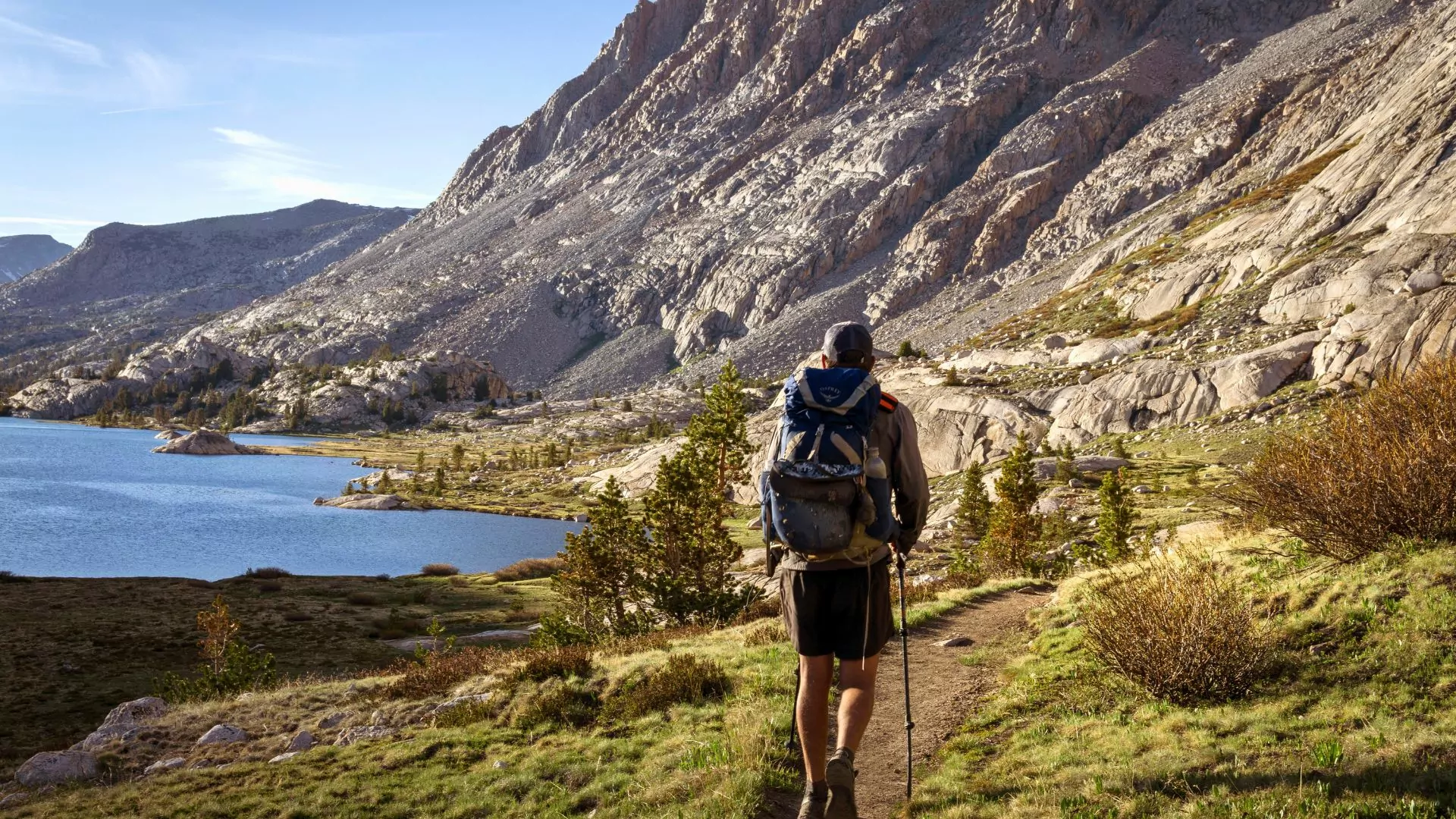 A backpacker with a midweight backpack hikes on a trail
