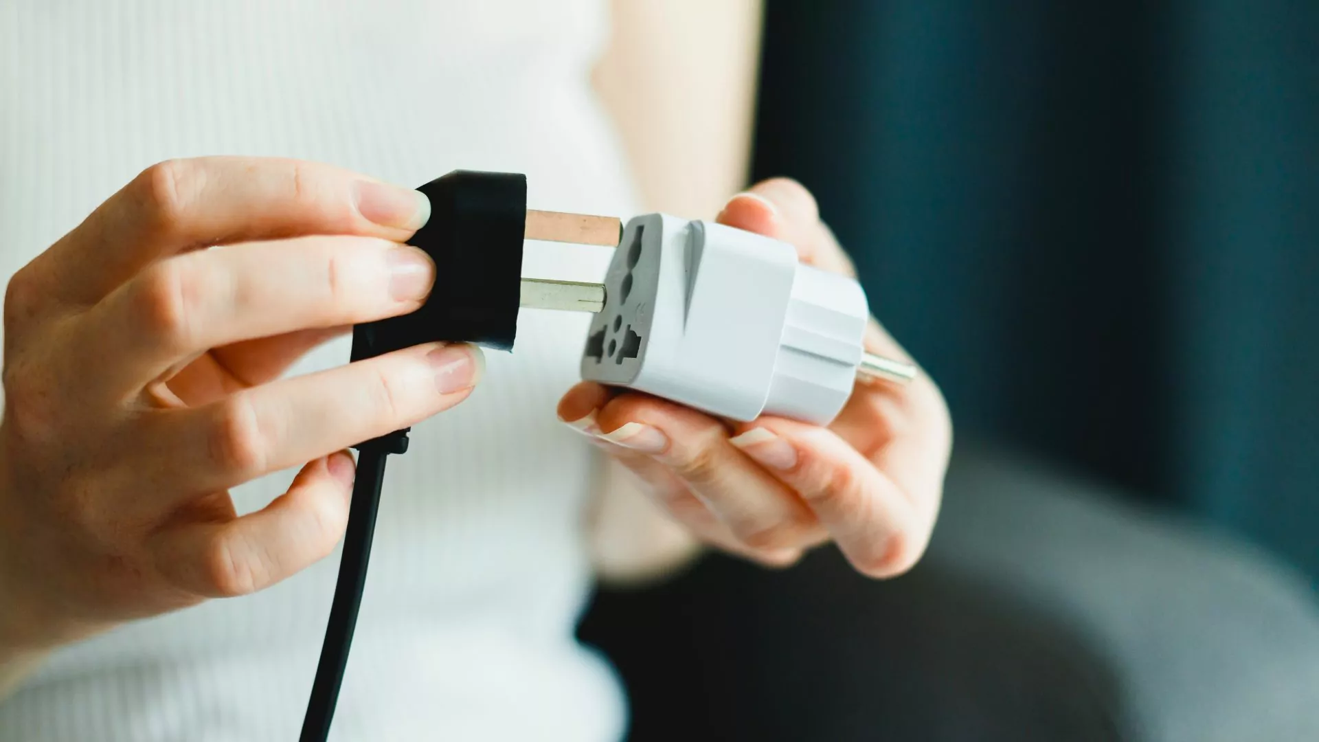 A woman uses an international outlet adapter
