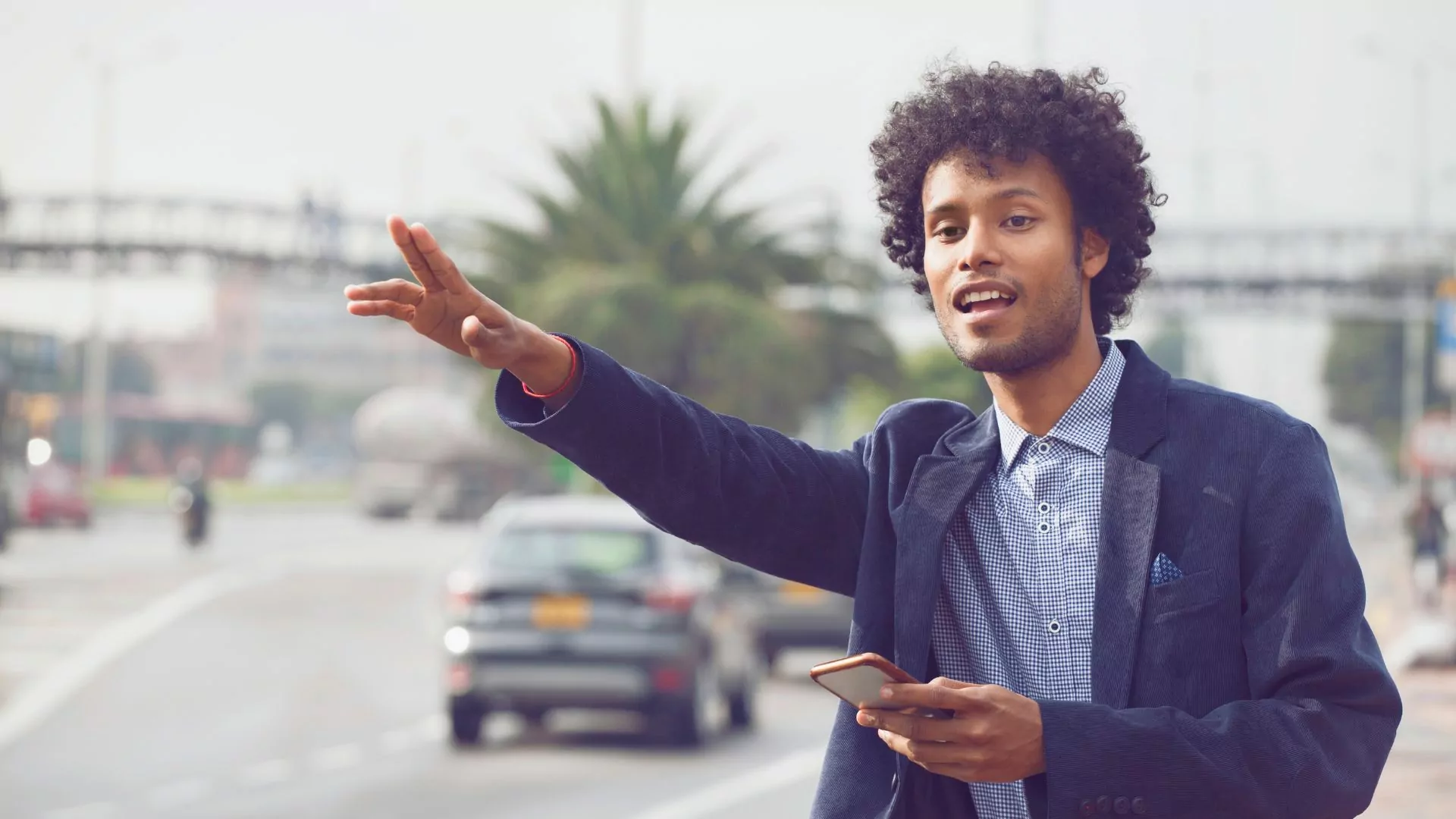A man hails a car in an international destination