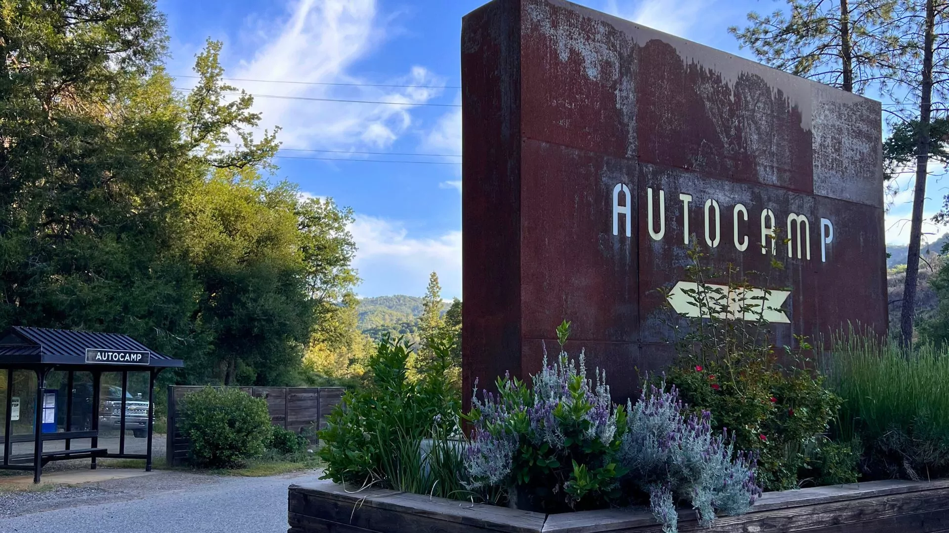A metal sign in Yosemite reads "Autocamp"