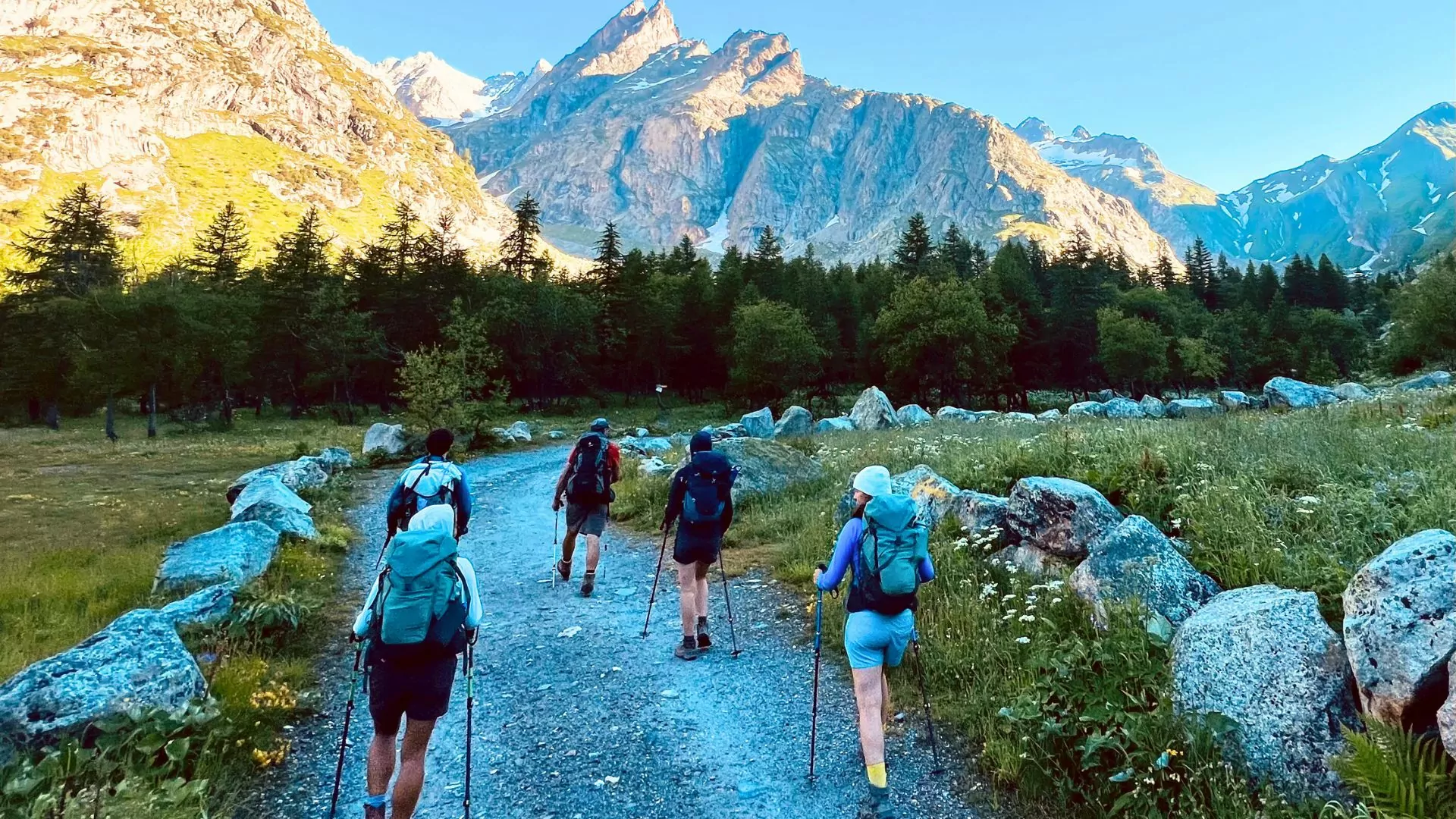 Hikers set off on a wide trail in the Dolomites
