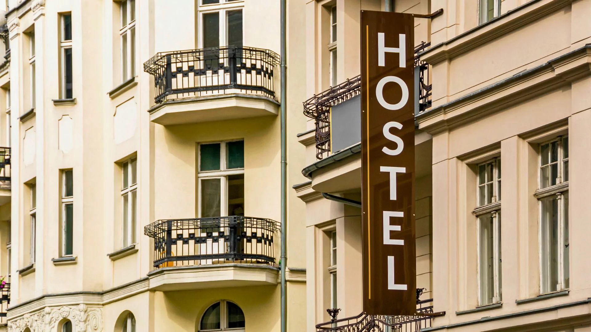A sign reading "hostel" appears outside a building