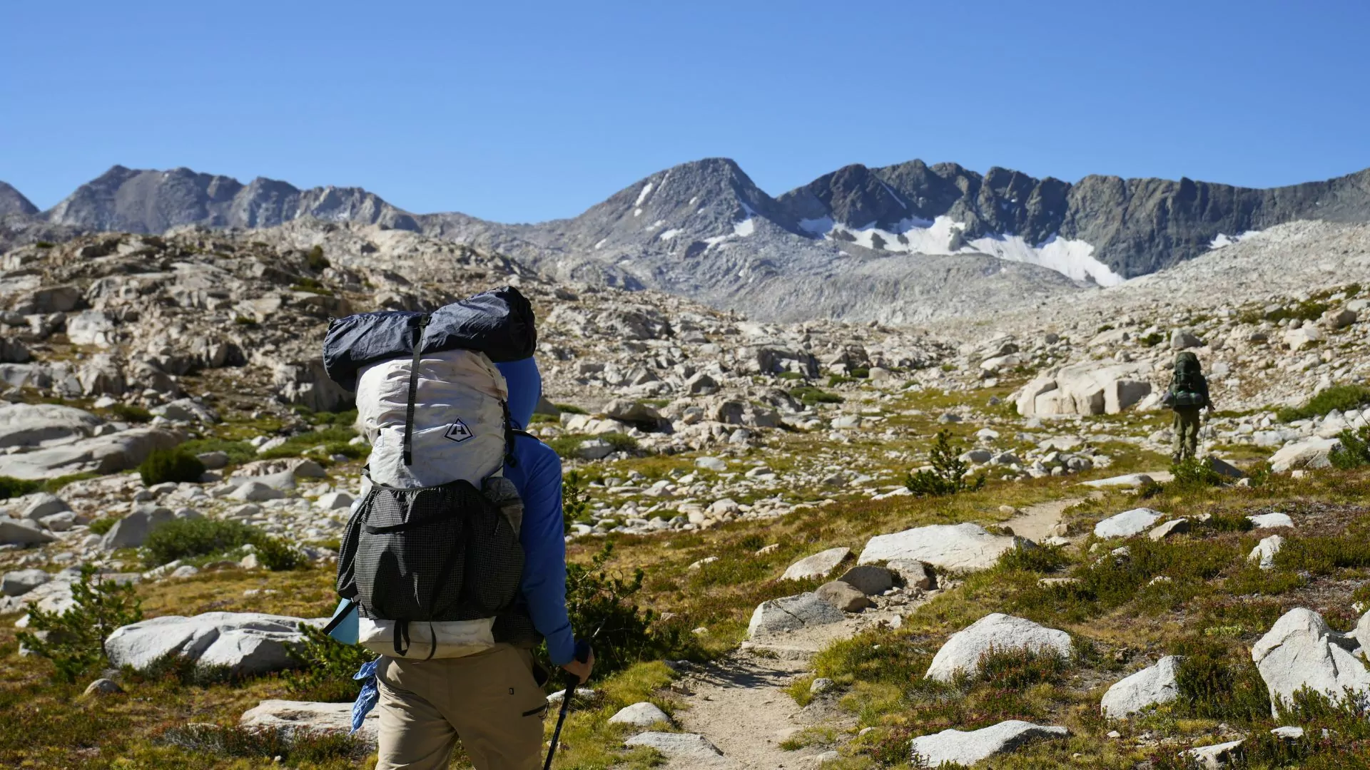 A hiker wears a Hyperlite Mountain Gear backpack