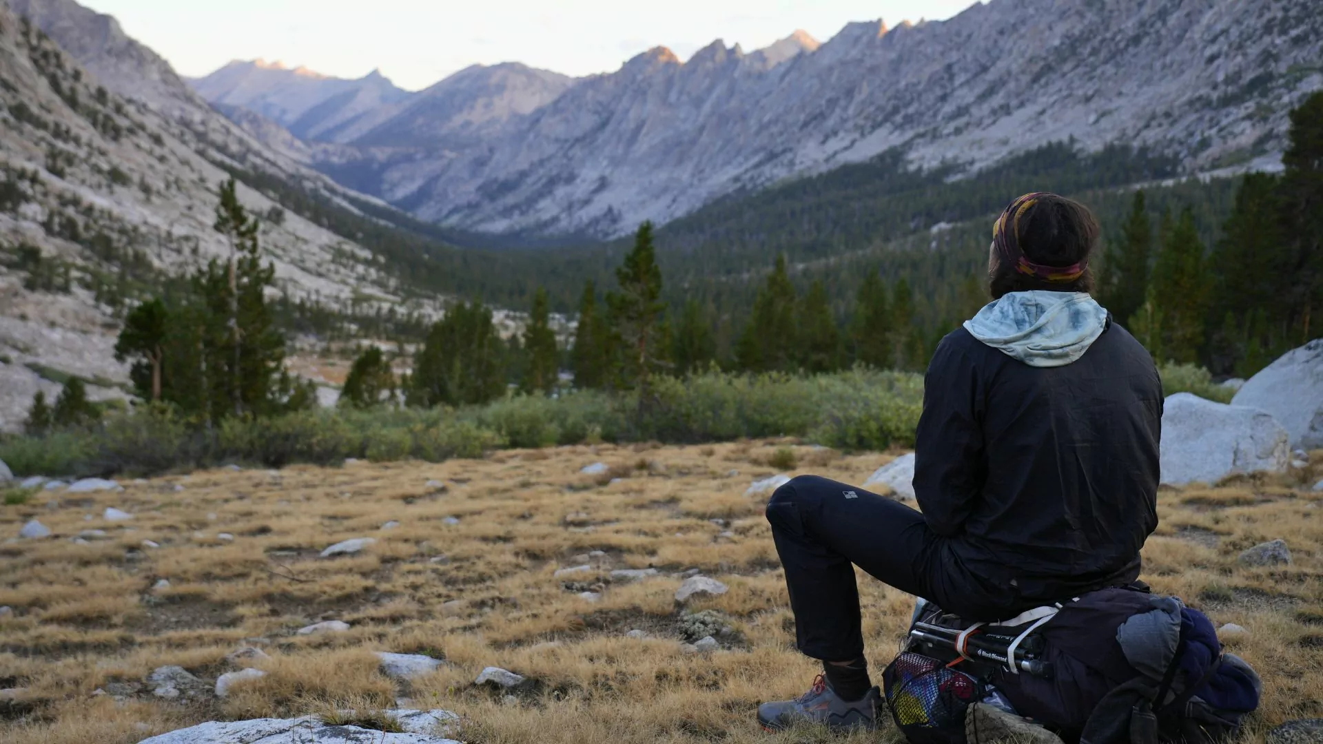 A hiker rests in the mountains