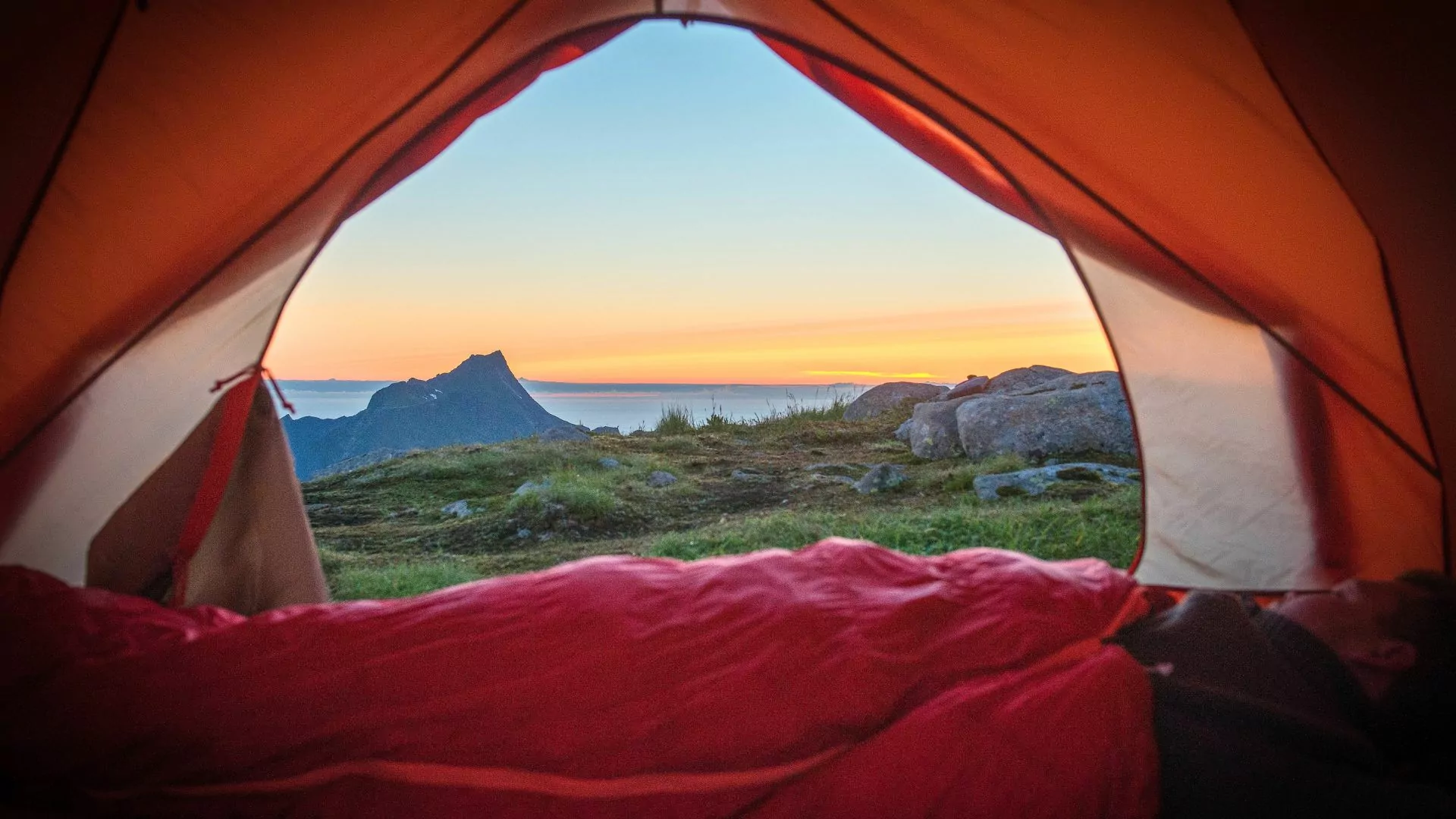 Looking out from inside a tent in a lsleeping bag