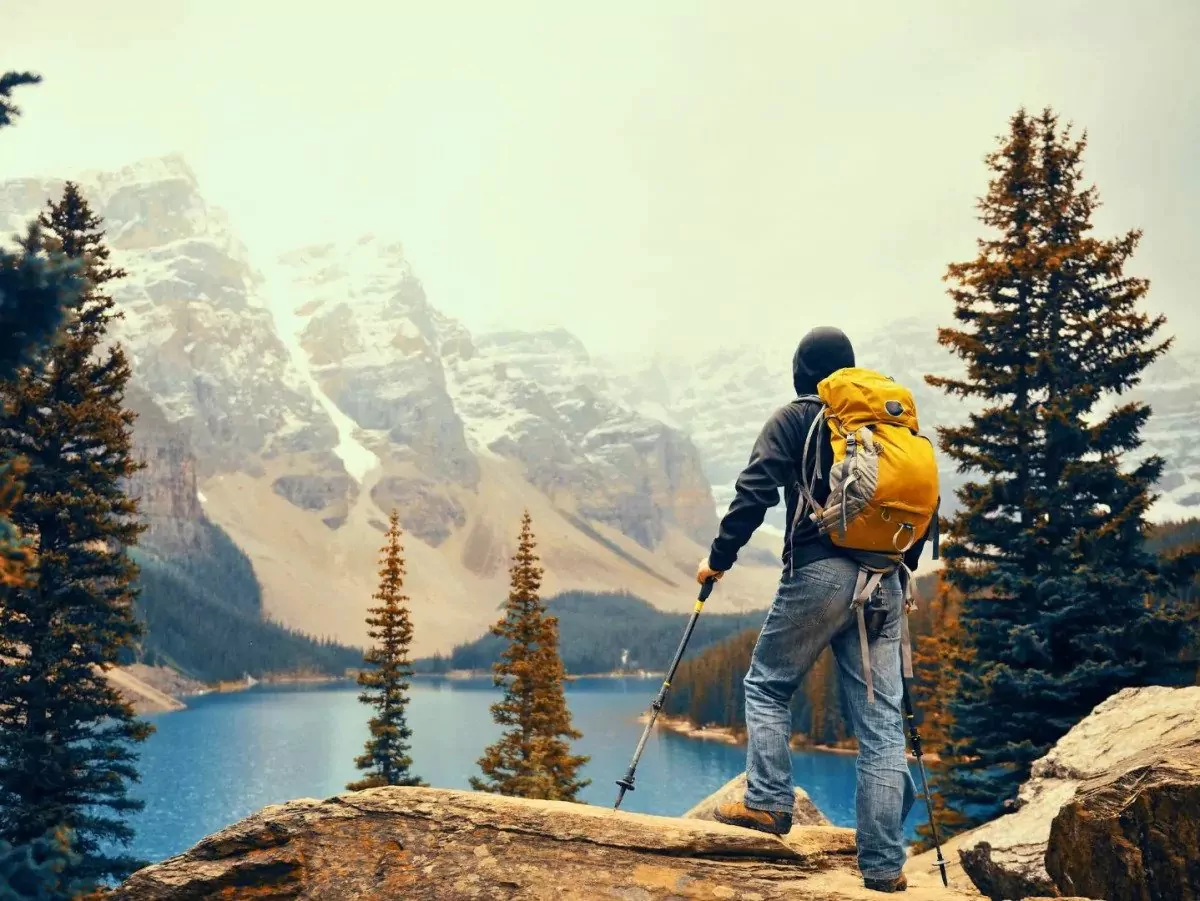 A hiker looks out on Banff National Park in the Canadian Rockies||Johnston Canyon trail in Banff National Park|Lake Louise lakeshore in Banff National Park