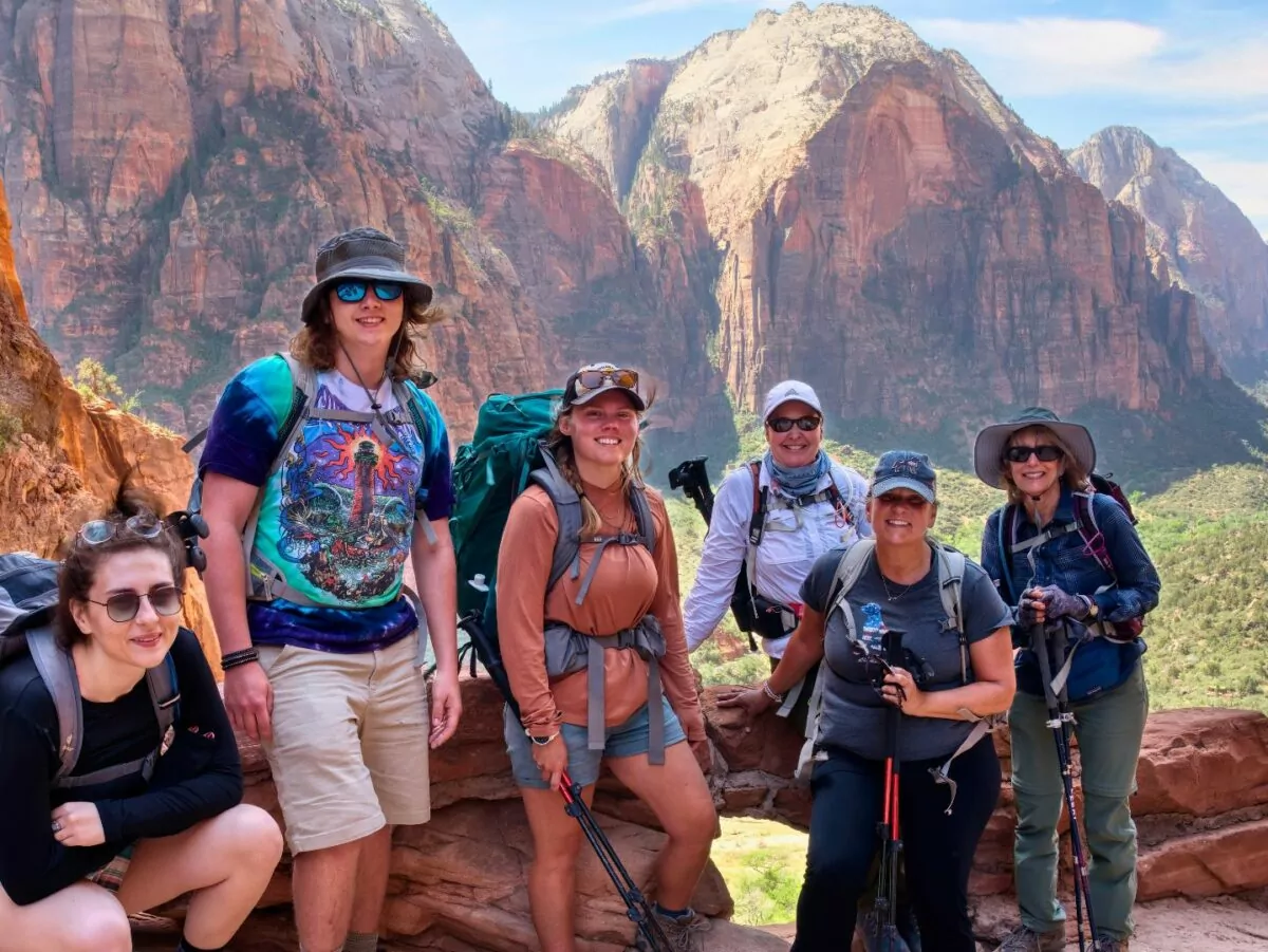 A group of hikers and their guide pose in Zion