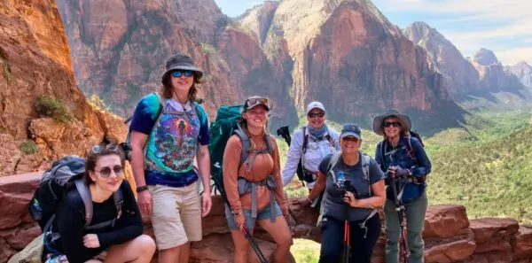 A group of hikers and their guide pose in Zion